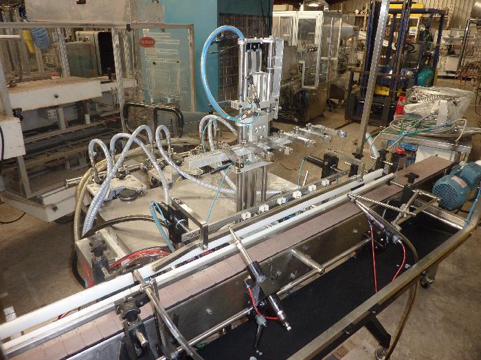 Remplisseuse liquide linéaire et volumétrique Universal PM MK2 PT4 d'occasion - 6 pompes en ligne de 50 à 500 ml_0