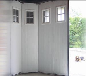 Porte de garage sectionnelle / motorisée / ouverture latérale / en panneau sandwich / avec portillon et hublot / isolation thermique / étanche à l'air_1