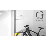 Système mécanique de stationnement vertical pour vélos avec assistance 